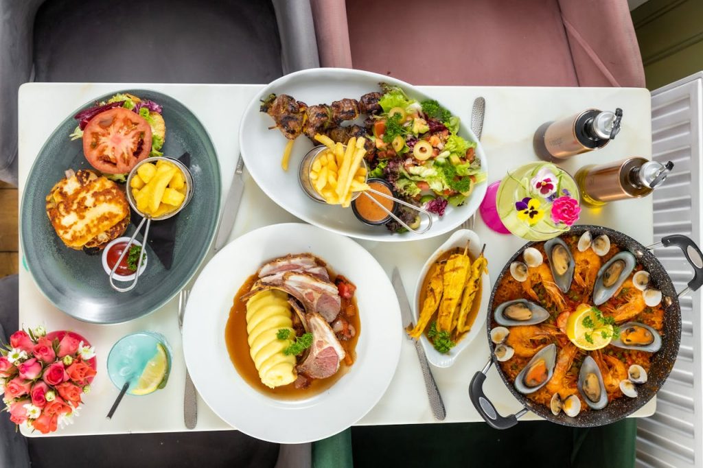 A variety of delicious dishes presented on a white table, capturing an upscale dining experience.
