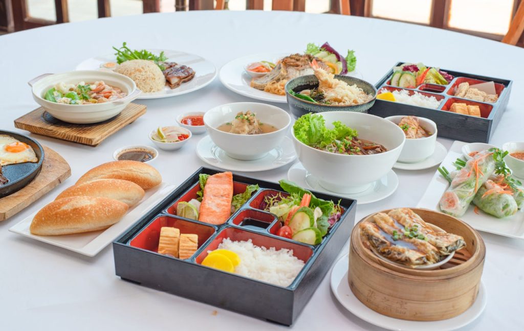 A variety of Asian dishes artistically arranged, showcasing diverse culinary delights for a sumptuous dining experience.